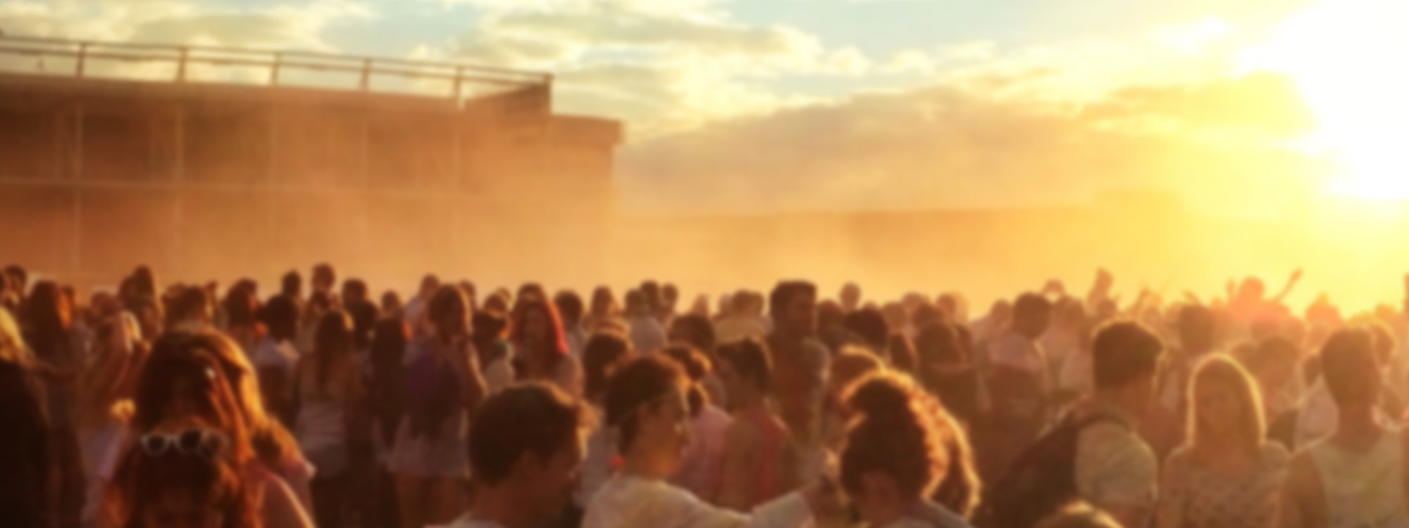 A crowd of people at sunset